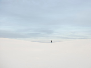 Person walking alone through White Sands National Monument