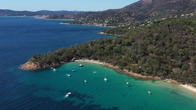Boat arriving at the Layet beach mediterranean coastline le Lavandou France sunny day aerial drone