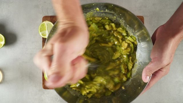 Hand mixing some avocado in a bowl
