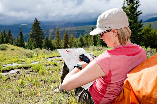 One woman maping her route with a GPS device near Andrews Lake, San Juan Mountains, Weminuche Wilderness, CO.