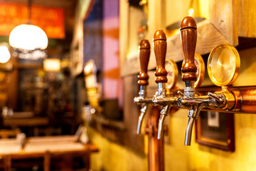 Beer taps on wall with wooden handles
