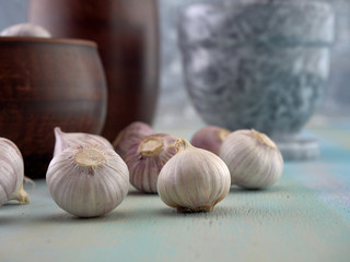 Garlic is in a clay bowl.On light background