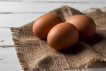 Fresh farm brown eggs over a rustic wood table