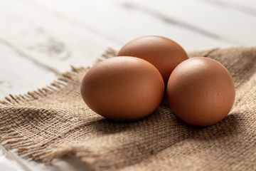 Fresh farm brown eggs over a rustic wood table