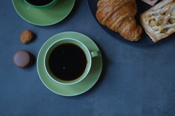  Breakfast with coffee, croissant and apple pie. Coffee composition on a dark background 