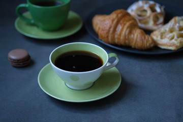 cup of coffee and cookies on table