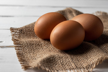 Fresh farm brown eggs over a rustic wood table