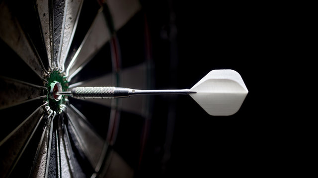 one dart in the center of a dartboard