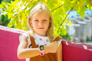 Modern technology for children. School girl using her GPS smart watch.  GPS kids tracker, kids...