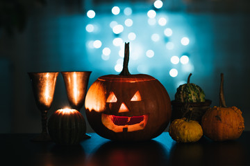 Halloween table decoration with Jack O' Lantern, pumpkins and candles