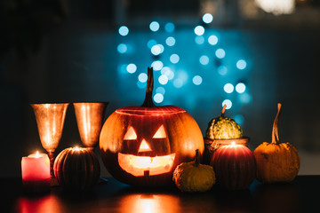 Halloween table decoration with Jack O' Lantern, pumpkins and candles