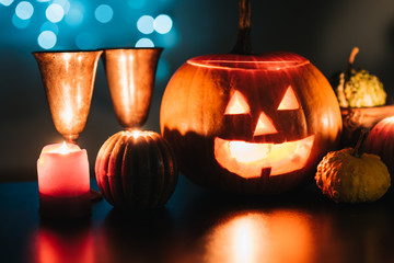 Halloween table decoration with Jack O' Lantern, pumpkins and candles