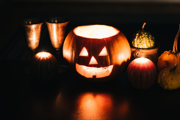 Halloween table decoration with Jack O' Lantern, pumpkins and candles