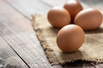 Fresh farm brown eggs over a rustic wood table