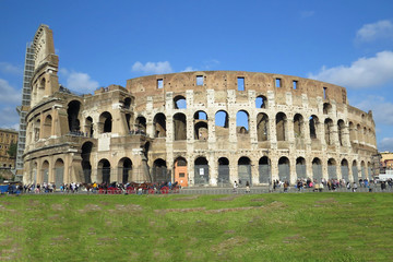 Fototapeta na wymiar Total view of the Roman colosseum in front of blue sky in Rome, Italy, Europe