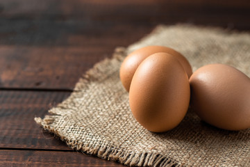 Fresh farm brown eggs over a rustic wood table