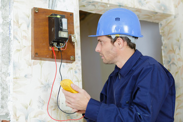 electrician apprentice on the electric fuse board