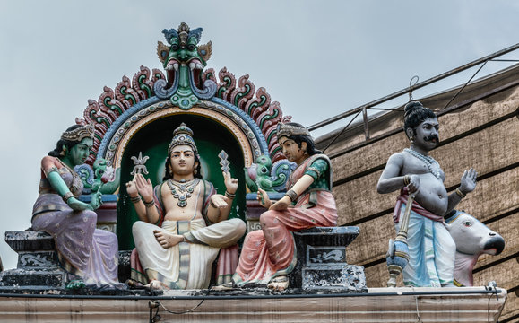 Singapore - March 22, 2019: Sri Mariamman Hindu Temple on South Bridge Road. Closeup of niche of Lord Murugan with two wives, Valli and Devasena, on outside wall.