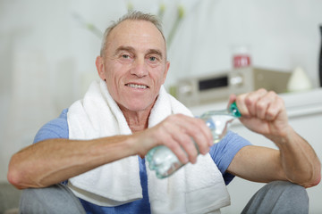 senior man working out with dumbbells in the gym