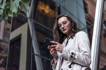 Business woman talking on smart phone. Business people office worker talking on smartphone smiling happy. Young multiracial Asian / Caucasian female professional outside.