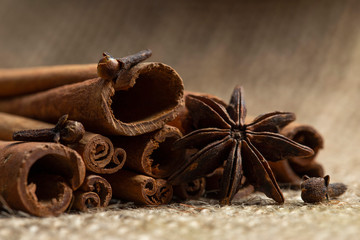 Cinnamon sticks, cloves and anise stars on a burlap