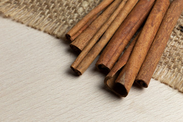 cinnamon sticks on wooden and burlap background