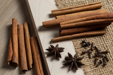 cinnamon sticks and star anise on wooden background