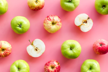 Autumn composition with fresh apples on pink background top view pattern