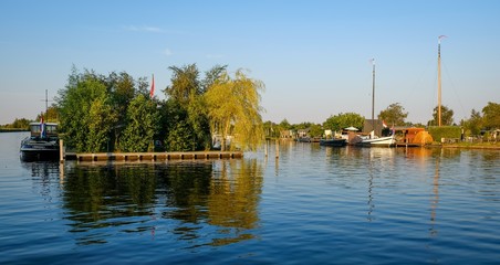 Fototapeta premium Dutch scenery with boats and trees in amsterdam