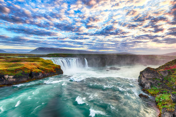 Fantastic sunset scene of powerful Godafoss waterfall.