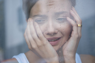 selective focus of upset young woman crying at home