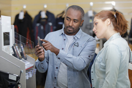 couple checking out the mobile in store
