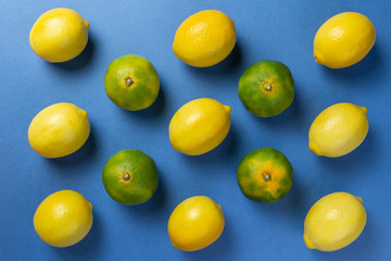 Lemons and mandarins on the blue backgruond. Flat lay.