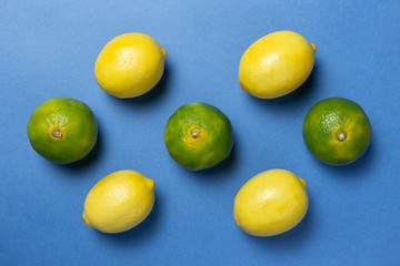 Lemons and mandarins on the blue backgruond. Flat lay.