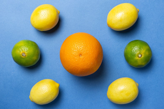 Orange, mandarins and lemons on the nlue background. Citrus mixed. Flat lay. 