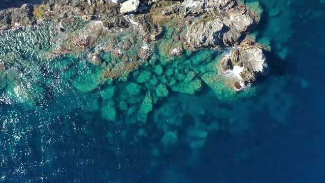 Clear water top aerial shot rocks and mediterranean sea France Porquerolles 