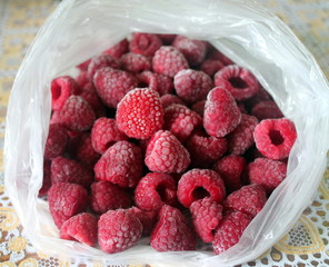 Many frozen organic raspberries in a package..