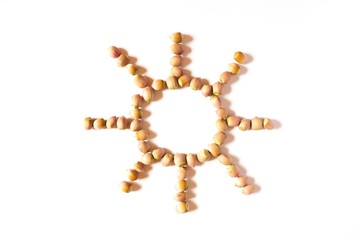 Shape of sun created of nuts. Creative still photo, top view, white background.