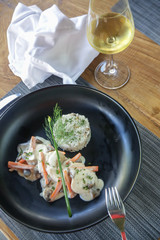 Poached chicken roll with white wine sauce served with mushroom pilaf rice. Exquisite dish. Creative restaurant meal concept. Haute couture food on black. Fine dining concept.