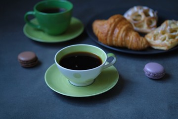 cup of coffee and cookies on table
