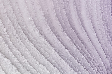 Abstract light purple picture. Toned photo of curved ice stripes. Unusual background for layouts and sites.