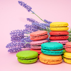 tasty colorful macarons on pink background