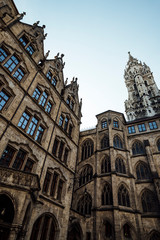 Fototapeta na wymiar The inside facade of the beautiful gothic style New Town Hall or Rathaus on Marienplatz in old town Munich, Bavaria, Germany. Vertical photo.