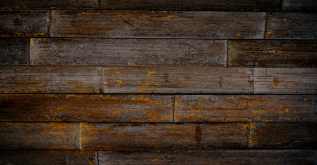 Warm orange and red brown reclaimed wood surface with aged boards lined up. Wooden planks on a wall or floor with grain and texture. Neutral stained vintage wood background.