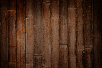 Warm orange and red brown reclaimed wood surface with aged boards lined up. Wooden planks on a wall or floor with grain and texture. Neutral stained vintage wood background.