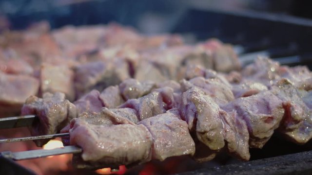 Closeup beef shish kebabs grilling outdoor. Pork shashlik barbecuing for picnic.