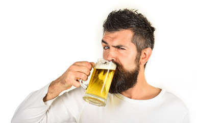 Beer pub. Beer time. Alcohol, harmful habits. Oktoberfest. Stylish handsome man drinking beer of glass on party. Smiling bearded hipster drinking craft beer from mug. Brewing. Stylish guy at cafe pub.