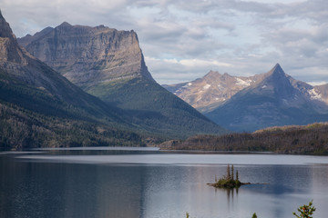 Beautiful View of a Glacier Lake with American Rocky Mountain Landscape in the background during a Cloudy Summer Morning. Taken in Glacier National Park, Montana, United States.