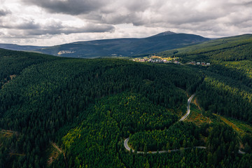 Aerial drone photography of a road in the mountains, top-down view. Poland, Czech Republic border. 