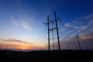 The electric pole is in the evening